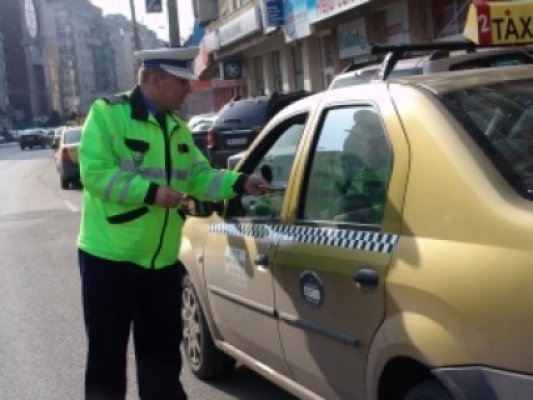 Poliţist târât pe şosea de un taximetrist